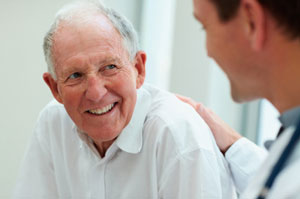 Older man talking to doctor