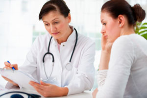 Woman talking to female doctor Woman talking to female doctor